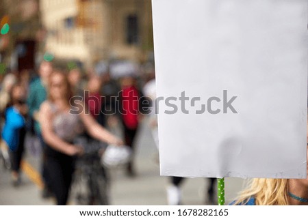 Protesting people holding a banner sideways with no words on a global warming protest