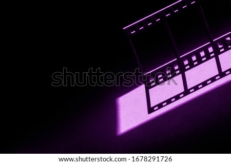 Movie background.Film reel stripe cinema on blue and black background with place for text