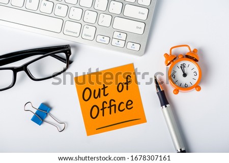 Out of office - memo on office workplace. Holiday Announcement, Day Off or Quarantine Covid-19 Royalty-Free Stock Photo #1678307161