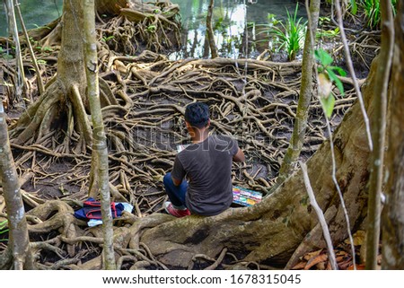 Painter to drawing a picture at  Tha Pom Khlong Song Nam the jungle river in  mangrove forest. 
