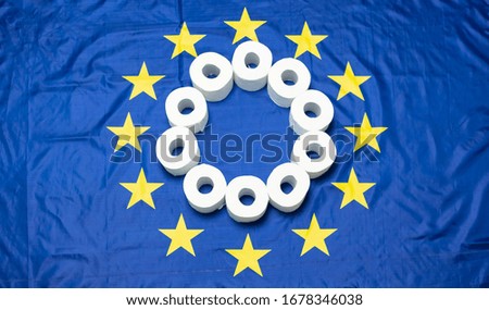 The concept of the pastime of the coronavirus pandemic in Europe in 2020 and the sale of products and toilet paper during quarantine in the European Union the background of the European flag.