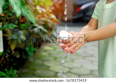 Close up of Asian girls washing their hands. Selective focus on hands