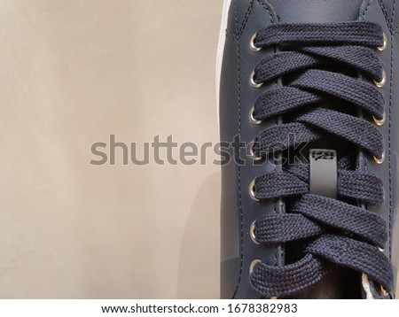 Sneakers close-up navy blue color gym fitness on gray background. Sport style fashion shopping.