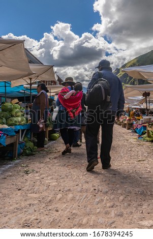 Picture from the back of a Peruvian man and woman at local market in Pisac village from Peru.