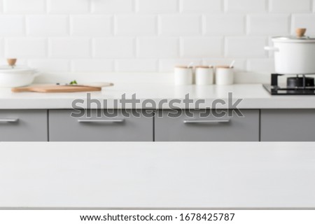 empty marble stone table top and blurred view of kitchen bench background.