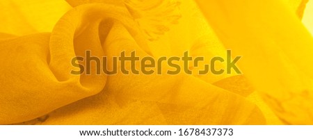 Background texture, yellow silk fabric with painted meadow flowers, colors between green and orange in the spectrum, the main subtractive color, painted like ripe lemons or egg yolks.