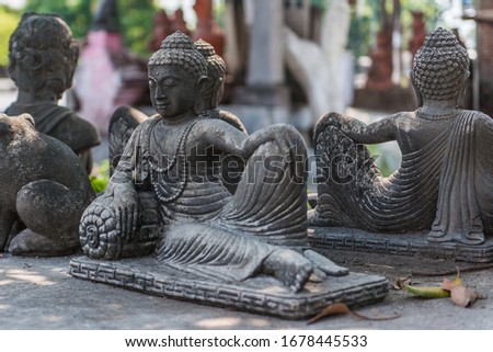 Statue of sitting Buddha made of stone at sculptors artist workshop. Mojokerto, East Java, Indonesia