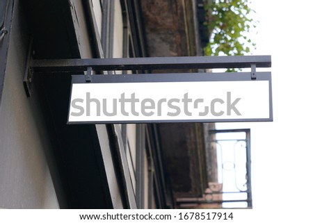Empty large signage white blank mock up horizontal hanging on street with copy space