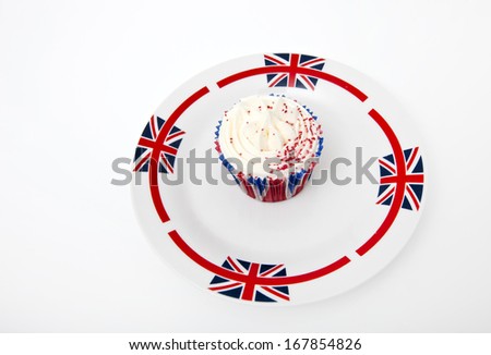 Cupcake in Union Jack plate against white background