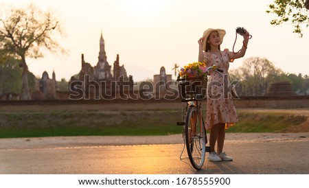 woman tourist enjoy walking to see the historic park of Thailand, exciting to explore the wonderful place of sightseeing. Travel Concept
