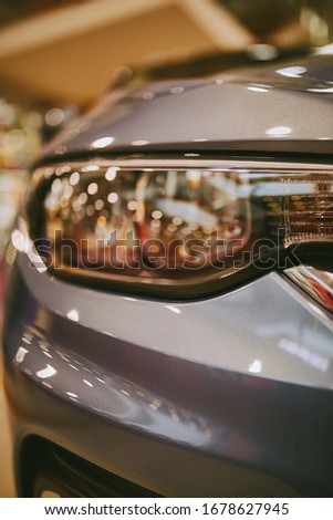 Headlights of a sports car in gray. Close-up photo of car headlights. car lights on bokeh background. vintage photo processing