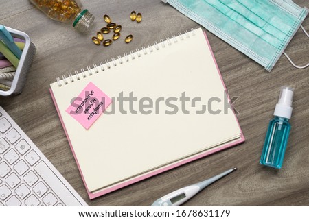 Pink Notepad with words# CORONAVIRUS #COVID-19 #stayhome on the book on office desk. Corona virus key facts health care message business concept. Royalty-Free Stock Photo #1678631179