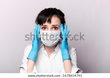 girl in a white shirt, a medical mask and gloves