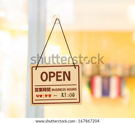 Open sign hanging on the door of bakery shop