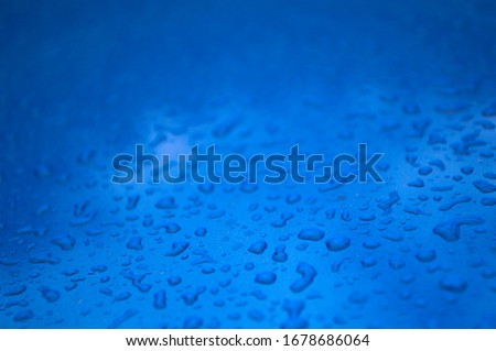 Blue car texture with raindrops on it.
