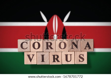 Flag of Kenya with wooden cubes spelling coronavirus on it. 2019 - 2020 Novel Coronavirus (2019-nCoV) concept, for an outbreak occurs in Kenya.