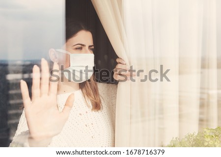 Young woman in medical mask stay isolation at home for self quarantine. Concept home quarantine, prevention COVID-19, Coronavirus outbreak situation Royalty-Free Stock Photo #1678716379