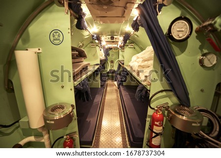 Inside the divers decompression chamber, bed room. Royalty-Free Stock Photo #1678737304