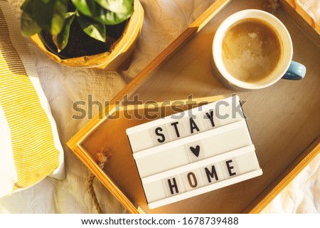 Stay home concept of self-isolation during the Covid-19 coronavirus pandemic. Cozy light home interior. Royalty-Free Stock Photo #1678739488