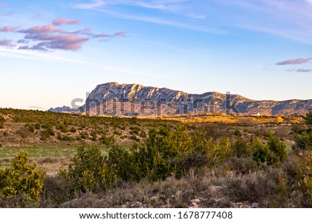 North face of the Pic Saint-Loup, illuminated by the setting sun, in a quasi-desert landscape