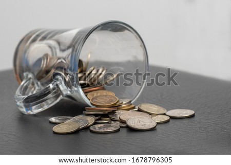 trifle Russian coins pouring from a glass jar on a dark background, the concept of coins of low denomination