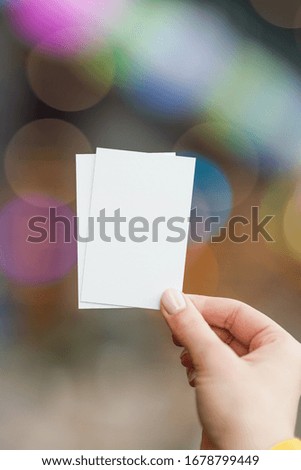 business card held in the hand of a young girl, brand identity mockup