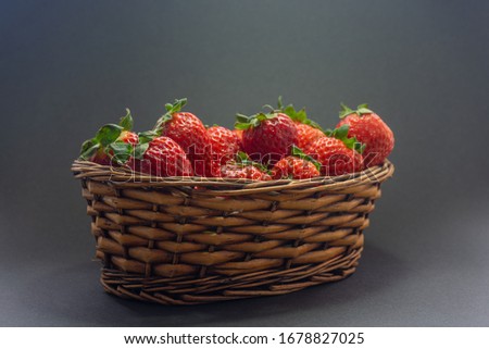 Strawberry basket with a black background.
