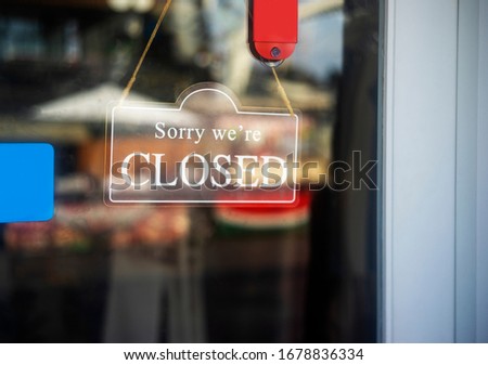 sorry we are closed sign hanging outside a restaurant, store, office or other