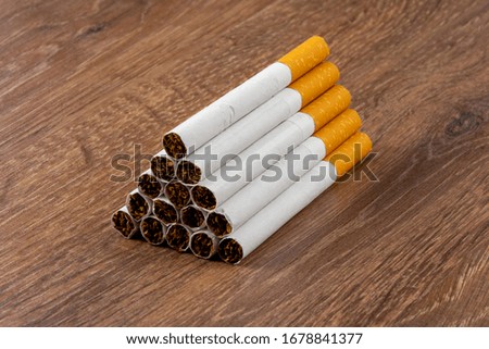 Close-up of filter cigarettes on wooden background
 Anti-smoking campaign
