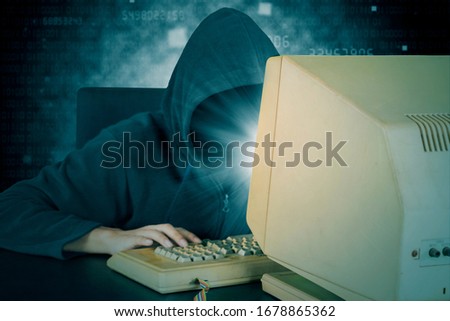 Portrait of male hacker stealing data information from system with binary code background 