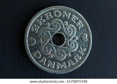 Close-up of two Danish kroner coin on black background. High resolution photography.