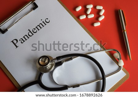Folder with the word Pandemic with a stethoscope and some pills