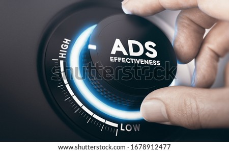 Finger turning an ads effectiveness knob in the highest position. Effective advertising campaign concept. Composite image between a hand photography and a 3D background.