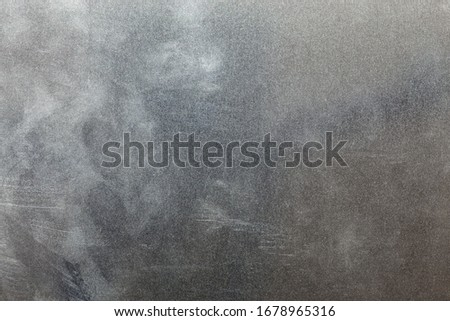 Uncoated flat cold rolled steel sheet surface with finger prints and hand fat dirt. Close-up in directly above composition.