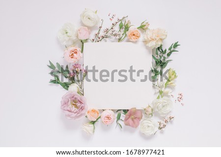 Elegant floral composition with paper blank in the centre. Branding mock up,  holiday marketing concept.