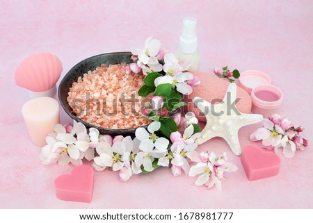 Vegan skincare beauty treatment with spa, ex foliation & cleansing products with apple blossom flowers on pink background. Health care anti ageing concept.