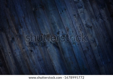 Dark diagonal stained, deep blue painted wood rustic grunge planks creative background. 