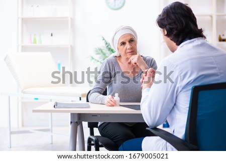 Young male doctor and female oncology patient Royalty-Free Stock Photo #1679005021