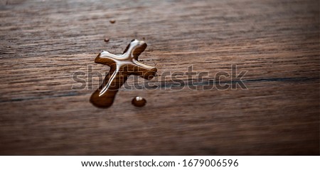 Water drop cross on wood