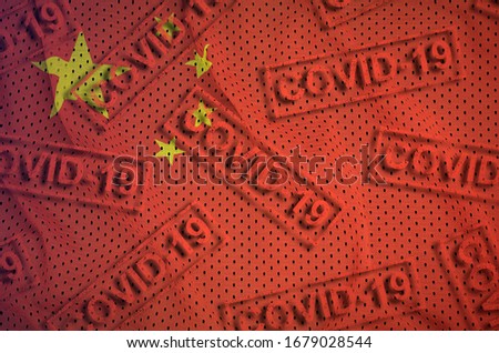 China flag and many red Covid-19 stamps. Coronavirus or 2019-nCov virus concept
