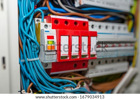 Surge arrester used to protect the electrical system in the building during electrical discharges, storm protection. Royalty-Free Stock Photo #1679034913