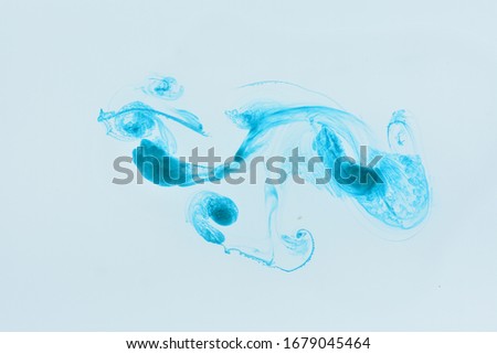 Aqua Blue ink in water on a white background. Abstract  heart shaped watercolour paint splash background.