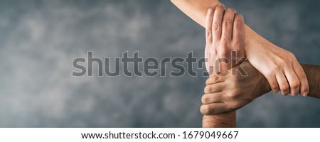 Top view of young people holding hands. Symbol and concept of unity, teamwork and support. Royalty-Free Stock Photo #1679049667