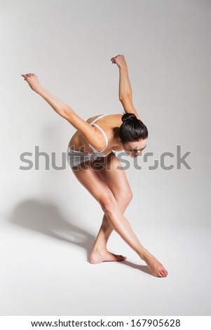 bending ballerina in studio