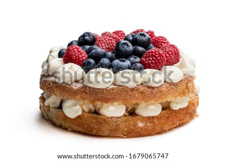 Victoria  sponge cake with whipped cream and berries on top isolated on white  Royalty-Free Stock Photo #1679065747