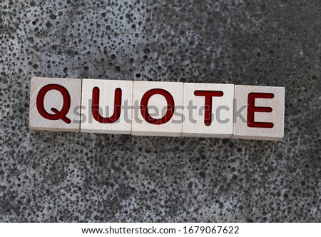Quotes - word from wooden blocks with letters, citation official notice or quotation concept, grey background