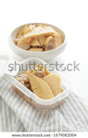 Japanese food, bamboo shoot and chicken simmered in food container 