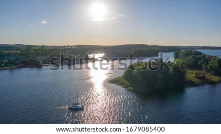 Beautiful panoramic aerial view photo from flying drone to Lake Galve on a sunny summer day.There are many boats and yachts on the lake.There are many small islands in the middle of the lake.Lithuania