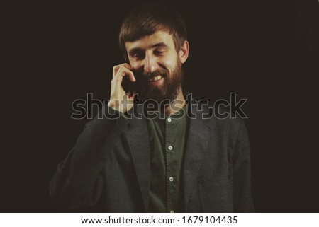 Businessman. Bearded businessman dressed in a suit on a black background. Businessman of European appearance. Vintage photo processing 