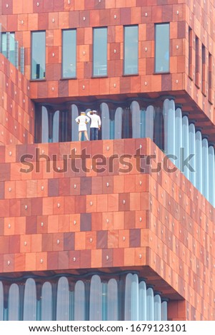 Cityscape - view of a fragment of the Museum aan de Stroom building  located along the river Scheldt in the Eilandje district of Antwerp, in Belgium Royalty-Free Stock Photo #1679123101